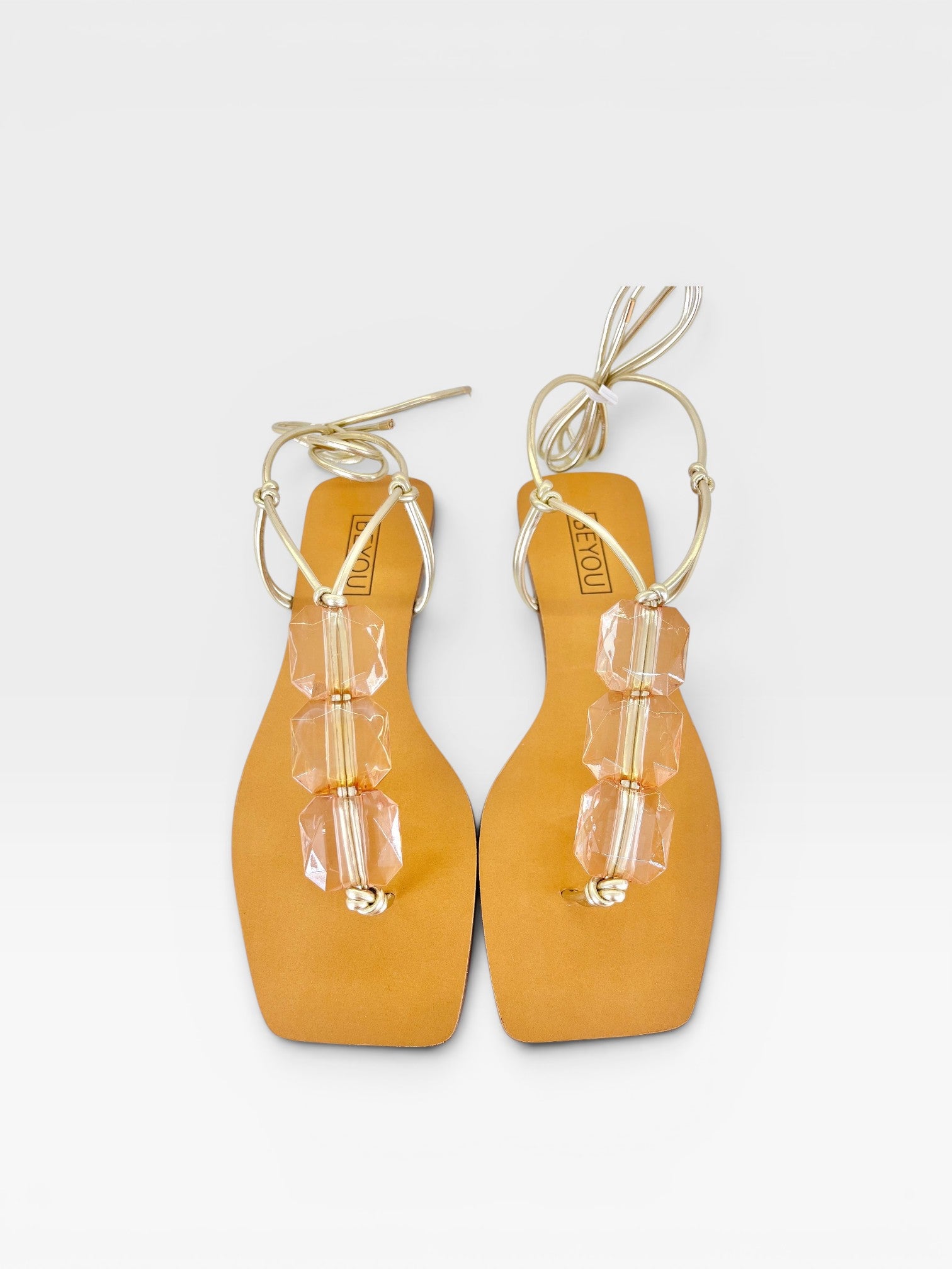 Rasteira Beyou Shoes caramelo em napa com pedrarias transparentes e amarração no tornozelo