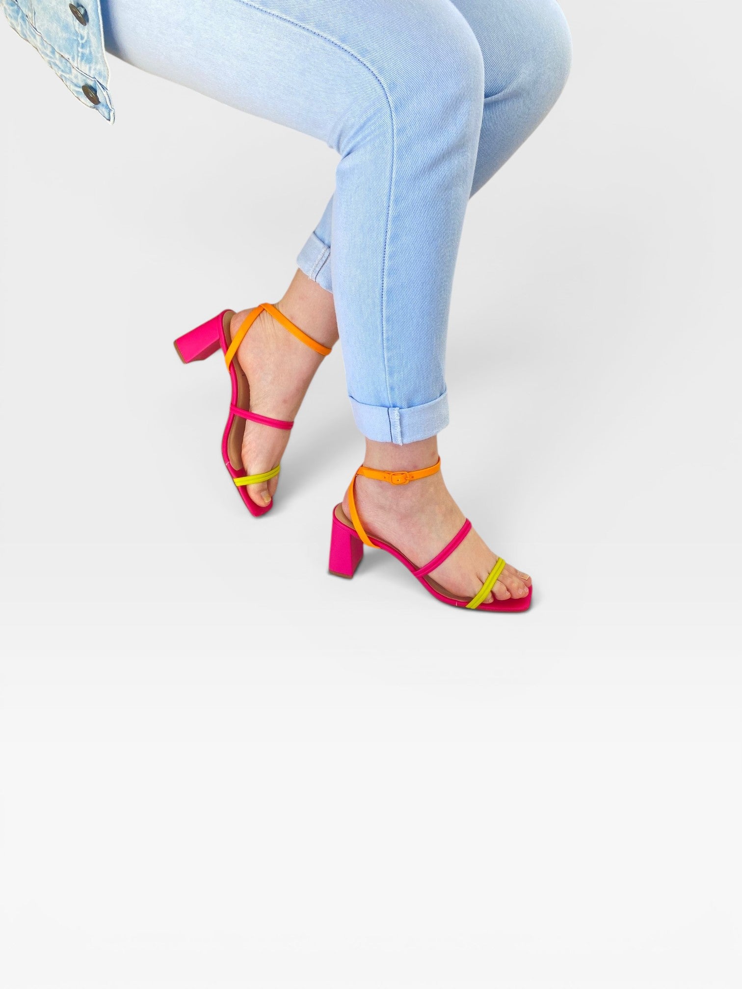 Sandália Beyou Shoes de salto bloco 7cm em napa rosa, limão e laranja, calçada em modelo com calça jeans clara.