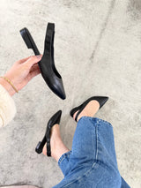 Slingback Barretos Beyou Shoes em couro preto com bico fino e design western, exibido no pé e na mão